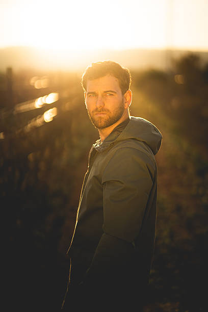 istock Man standing in golden sunset 2213785426