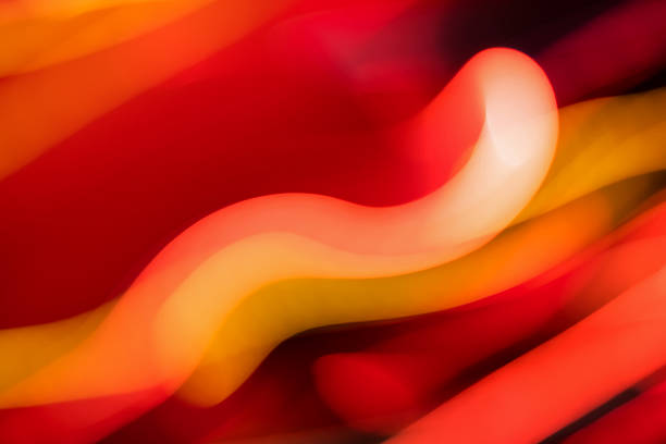 Abstract background made of motion blurred light trails in red tones. Dynamic image.