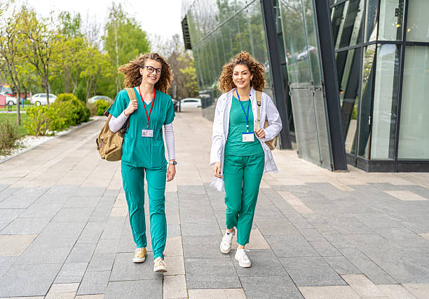 istock Two young nurses walking outside hospital building 2213786779