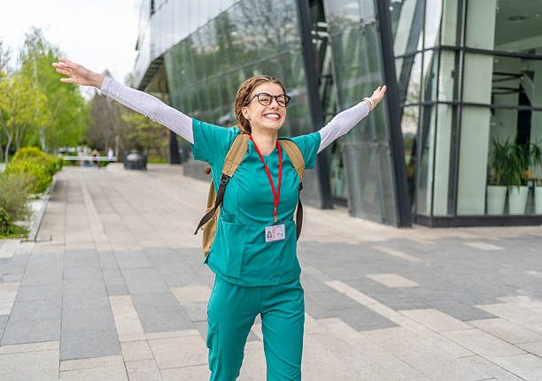 istock Happy nurse celebrating outside hospital after work 2213786873