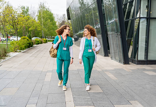 istock Two young nurses walking outside hospital building 2213787290