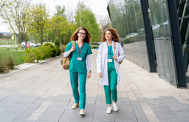 istock Two young nurses walking outside hospital building 2213787407