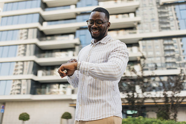 istock Smiling Man Checking Watch in Urban Environment 2213788568