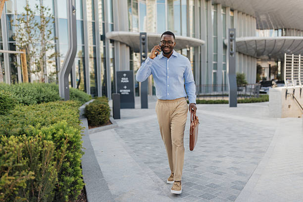 istock Lively Man on Phone While Walking in Urban Space 2213788693