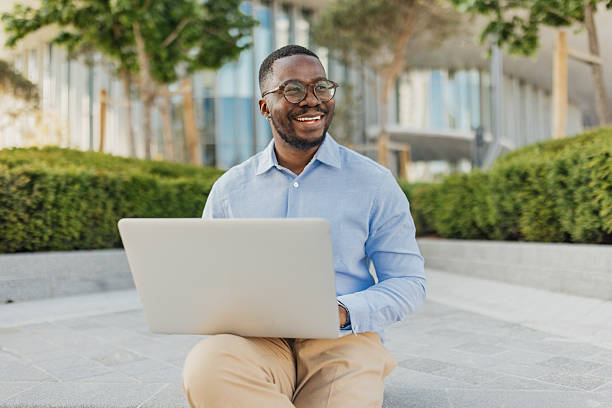 istock Smiling Professional Working on Laptop in a Garden 2213788750