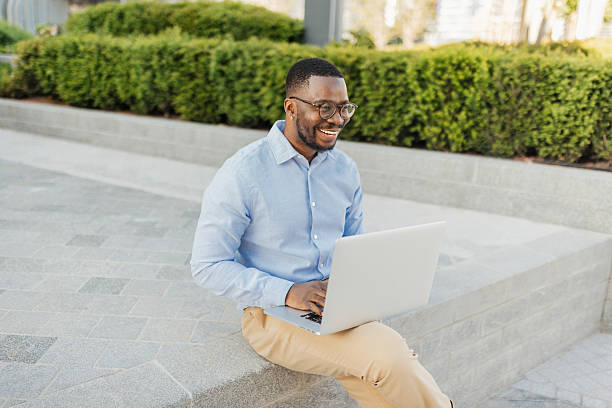 istock Happy Man Engaged on Laptop in Outdoor Workspace 2213788763