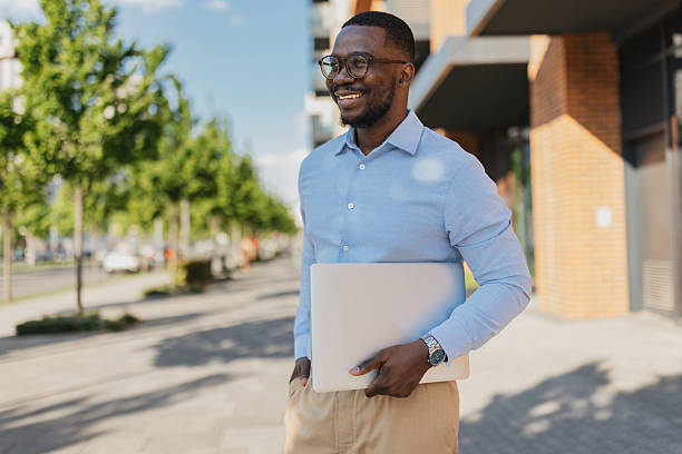 istock Happy man posing with laptop outdoors 2213788975