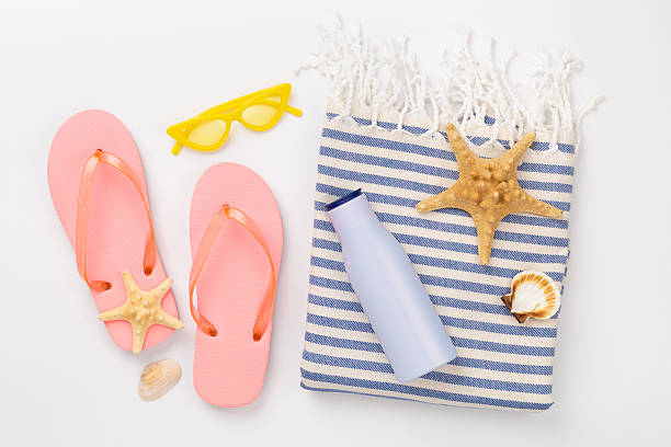 istock Beach towel with summer accessories on color background, top view 2213789953