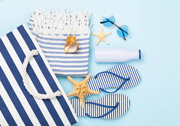 istock Blue beach bag with summer accessories on color background, top view 2213789970
