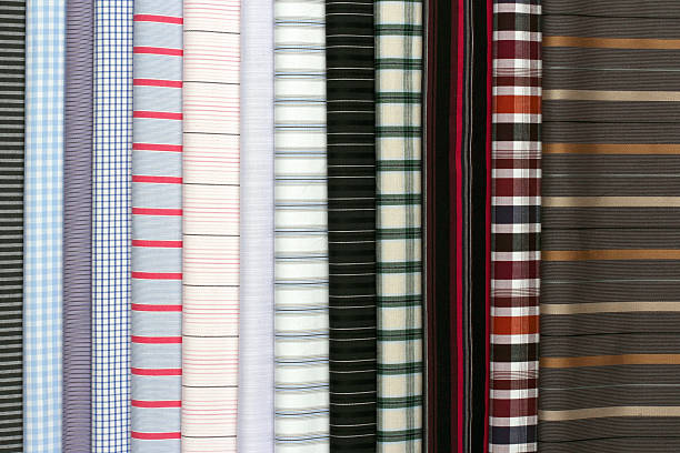 istock Stacked fabric samples with bold plaid and striped patterns in multiple colors, perfect for creative textile or fashion. 2213790294