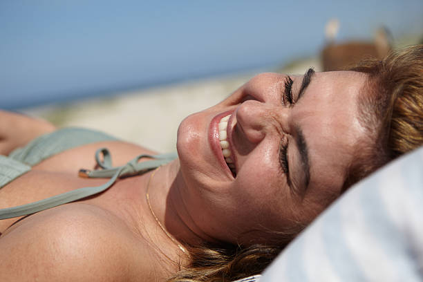 istock Smiling Woman Enjoying Sunny Day on a Relaxing Beach 2213791441