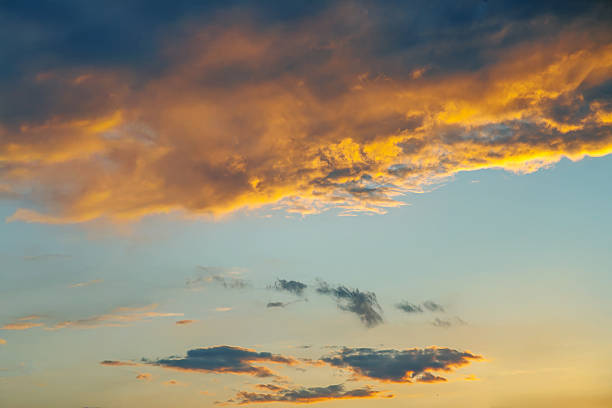 istock Ethereal sky filled with heavy clouds and golden light rays breaking through at sunset. Perfect for evoking emotion, nature photography, and creating a dramatic, serene ambiance. 2213791477