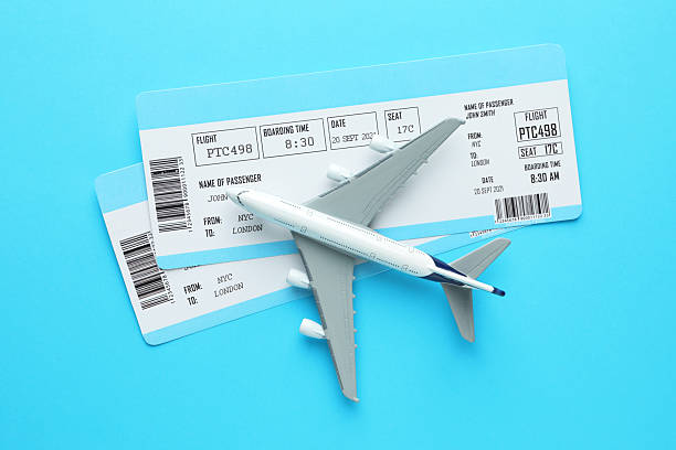istock Travel agency. Flight tickets and plane model on light blue background, flat lay 2213792059