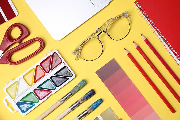 istock Designer's workplace. Flat lay composition with stationery and laptop on yellow background 2213792624