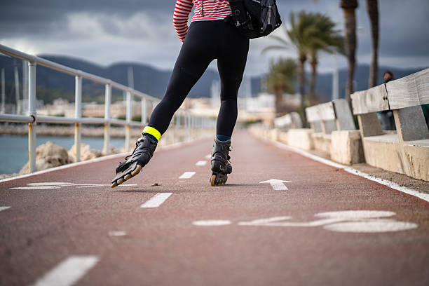 Woman roller skating along a seaside promenade, savoring fresh air and engaging in exercise, embodies a vibrant, healthy lifestyle filled with enjoyment and freedom