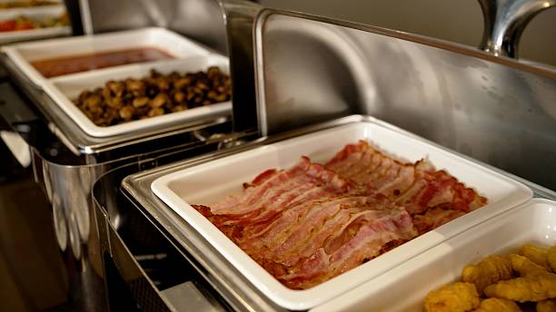 istock Delicious crispy bacon and chicken nuggets served on white ceramic trays 2213797349