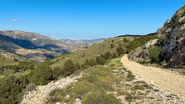 istock Experience stunning mountain trails under blue skies filled with sunshine and clouds 2213800578