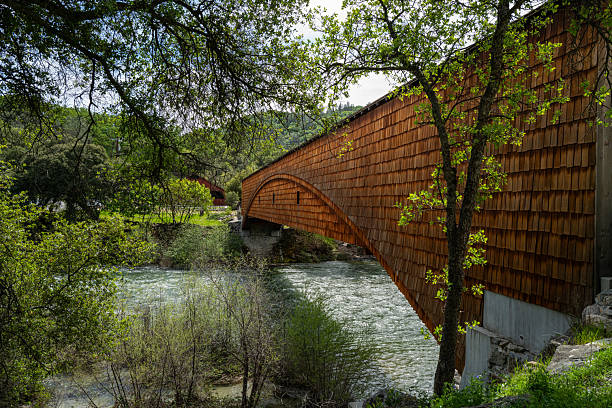 Side view of the Bridgeport covered Bridge over the South Yuba River in Nevada County, California. This bridge has the longest clear single span of any surviving covered bridge in the U.S.