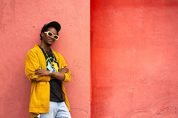 istock Carefree man leaning against wall 2213810144