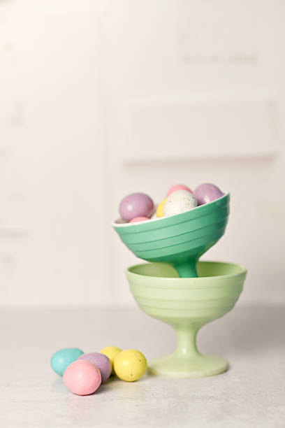 Multi colored hand-painted Easter eggs in the hay. Beautiful bokeh lights, space for copy.