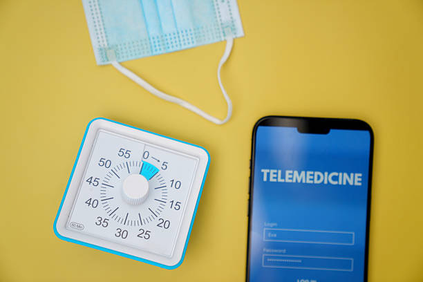 istock Telemedicine Concept with Smartphone Timer and Mask on Yellow Background 2213817860
