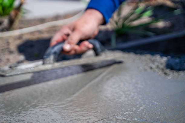 istock A man's hand is leveling freshly poured cement with a trowel, close-up 2213820690