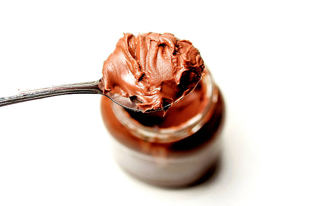 istock chocolate spread on spoon, isolated on white background 2213821522