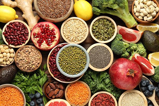 istock Different superfood products on wooden table, flat lay 2213825716