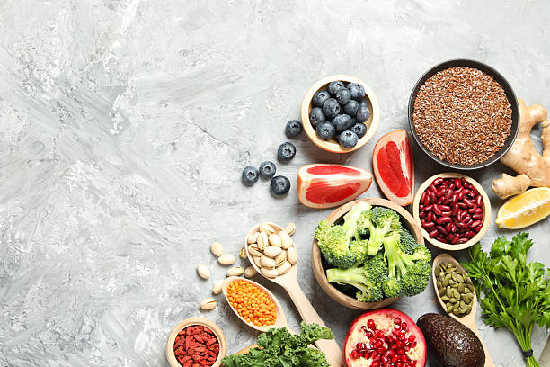 istock Different superfood products on grey table, flat lay. Space for text 2213825720