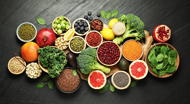 istock Different superfood products on black table, flat lay 2213825893