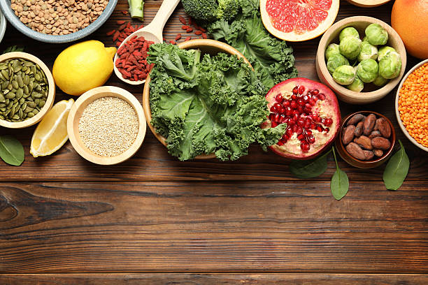 istock Different superfood products on wooden table, flat lay. Space for text 2213825908