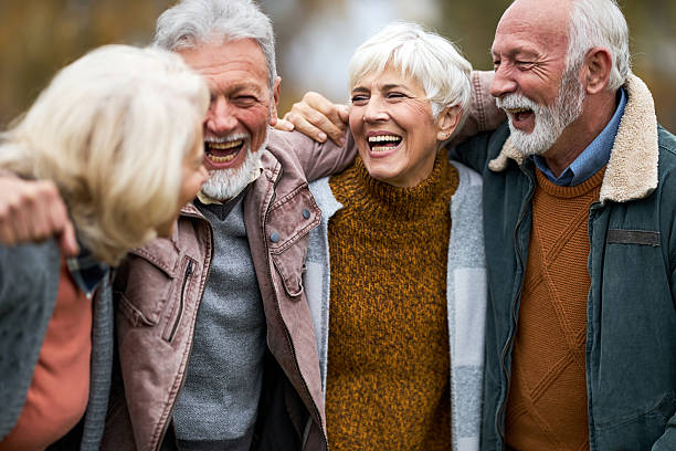 istock Cheerful senior friends talking embraced in nature. 2213830240