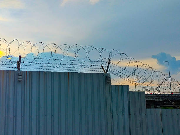 istock The fence has barbed wire on top. 2213830611