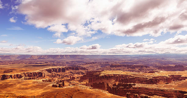 istock Clouds Stretching above the Rugged Terrain of Canyonlands 2213830799