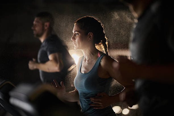 istock Athletic woman warming up on treadmill in a gym. 2213832167
