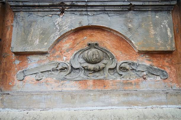 Beautiful background with white garland flowers stucco on the old white wall in the Thai temple.