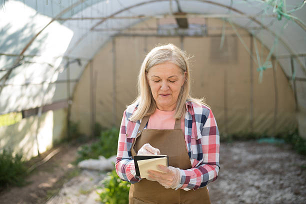 istock Greenhouse farmer updating a quality control checklist 2213835967
