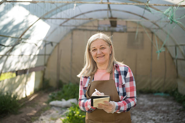 istock Greenhouse farmer updating a quality control checklist 2213835971