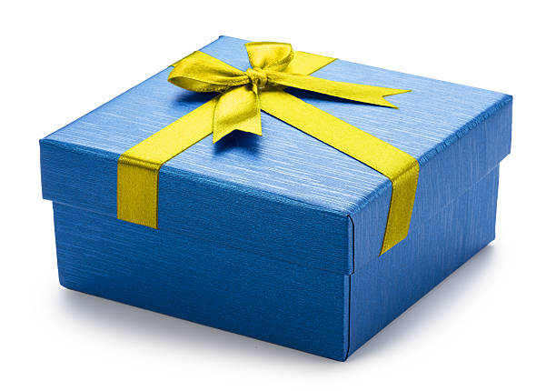Some Christmas presents with yellow bow and greeting card, lined up on a table.