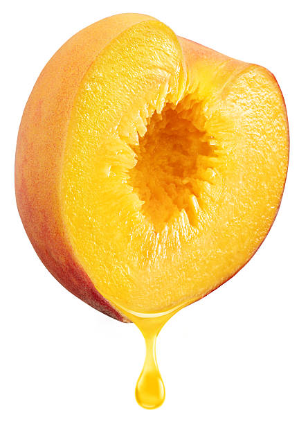 istock Slice of peach fruit and peach juice dripping from it on a white background. File includes clipping path. 2213836267