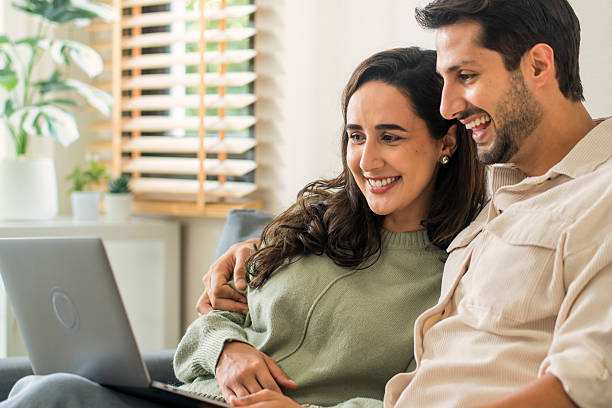 istock Tech-Savvy Duo: Love and Banking Online. 2213837800