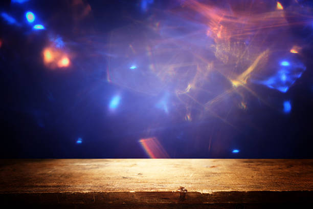 istock Wooden table and lights during night time. Product display or mock up 2213838037