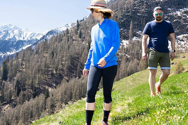 It is springtime in the high mountains surrounding the valley of Gressoney Saint Jean. On this glorious day, the sun is shining and nature is awakening from its winter hibernation. Here's a beautiful couple, proud of their fitness, on a bucolic trail leading to a small mountain hamlet, Alpenzu, where the legendary German-speaking mountain people, the Walser, lived in freedom since the Middle Ages.