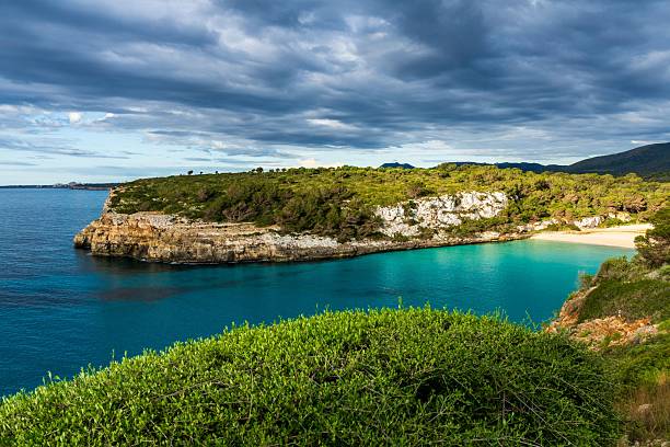 istock Cala Romantica Bay in Mallorca with Turquoise Water Cliffs and Dramatic Sky 2213840976