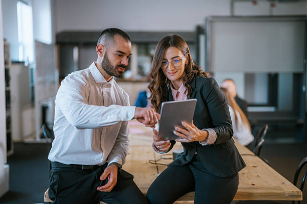 istock Professional colleagues collaborating on tablet device in modern office environment 2213845279
