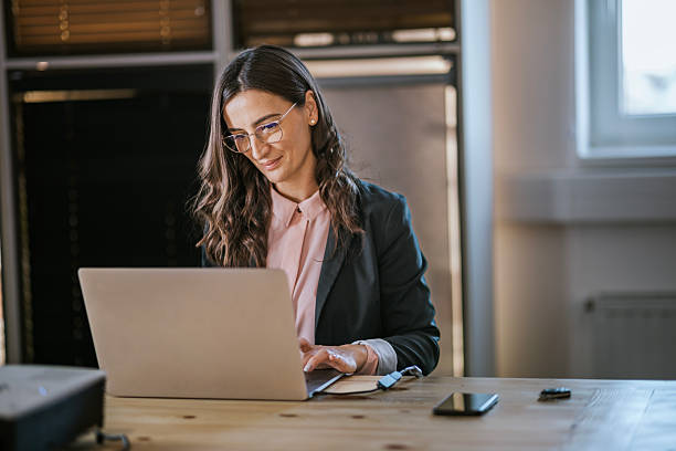 istock Businesswoman working on a laptop in a professional office setting 2213845685