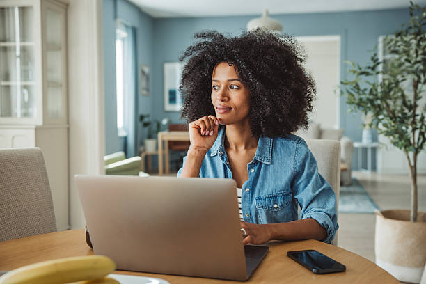 istock Young black beautiful woman using laptop at home 2213846045