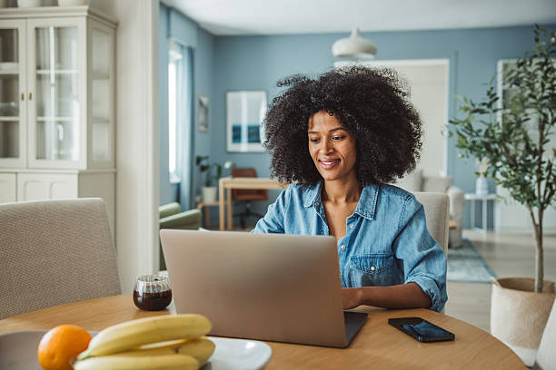 istock Young black beautiful woman using laptop at home 2213846050