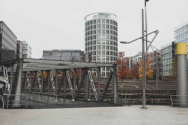 Modern glass architecture and yellow autumn tree in Hamburg