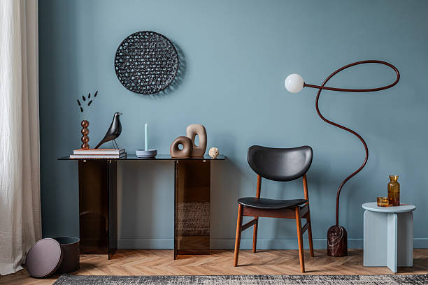 istock Sophisticated interior with a deep blue accent wall, smoked glass console, and sculptural decor pieces. 2213851032